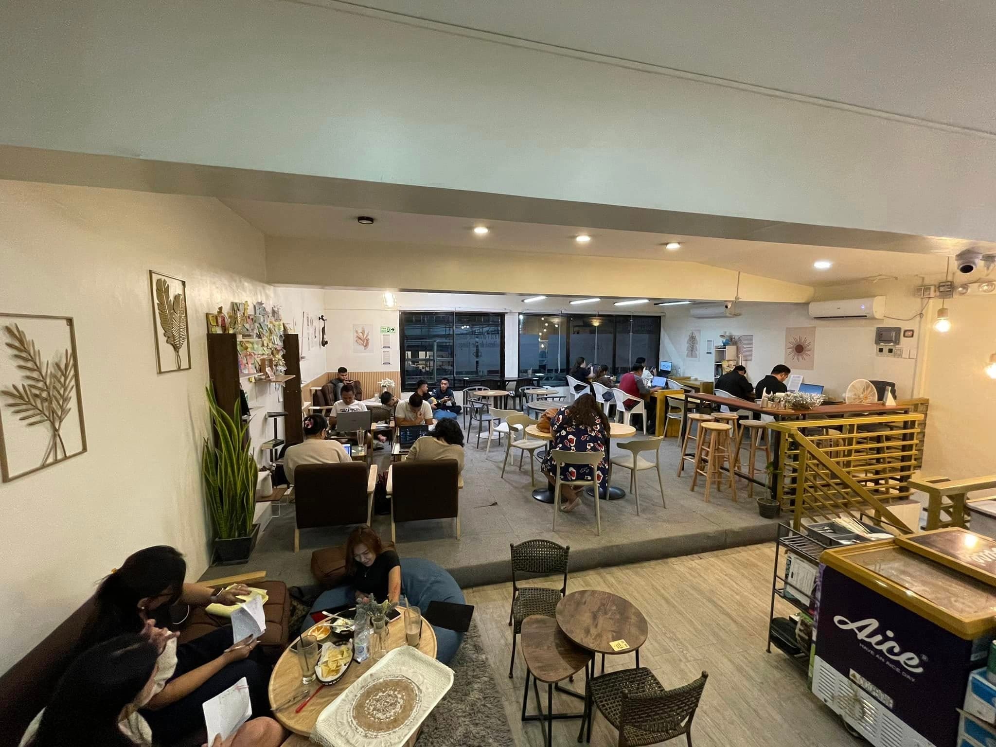 WeeCup cafe lounge area with tables and stairs