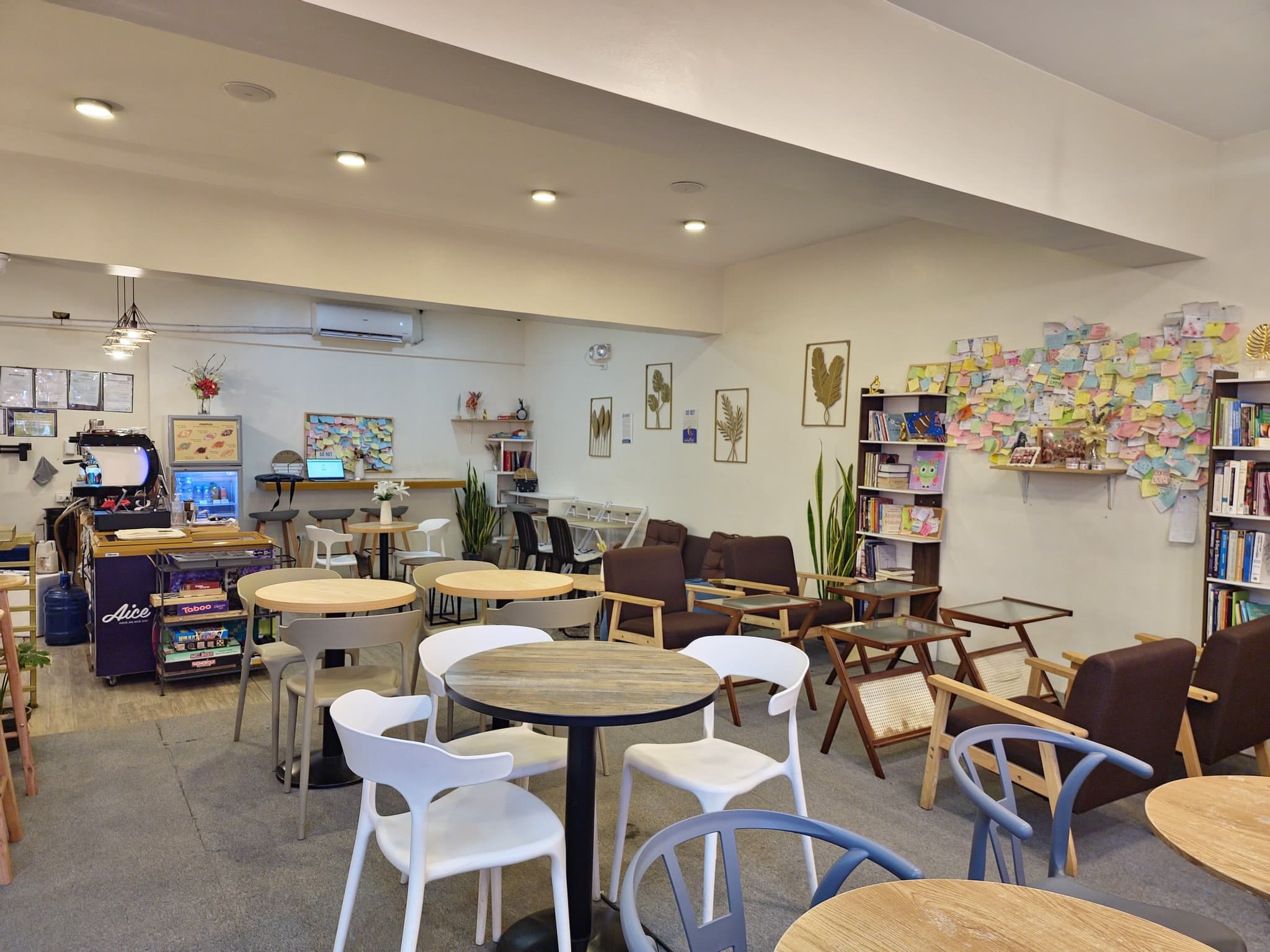 Empty round tables inside WeeCup Call Cafe