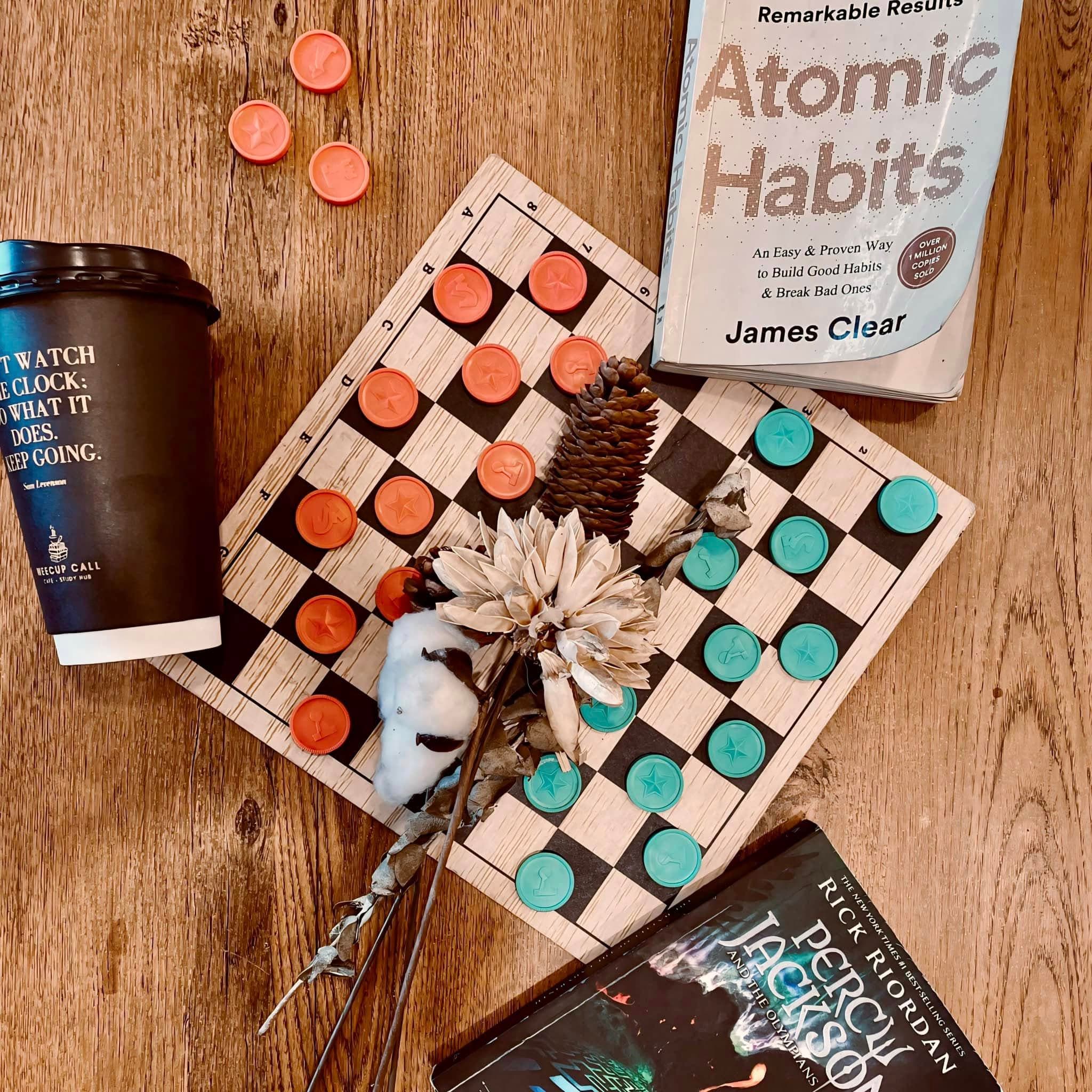 Coffee, book, and board game flat lay at WeeCup