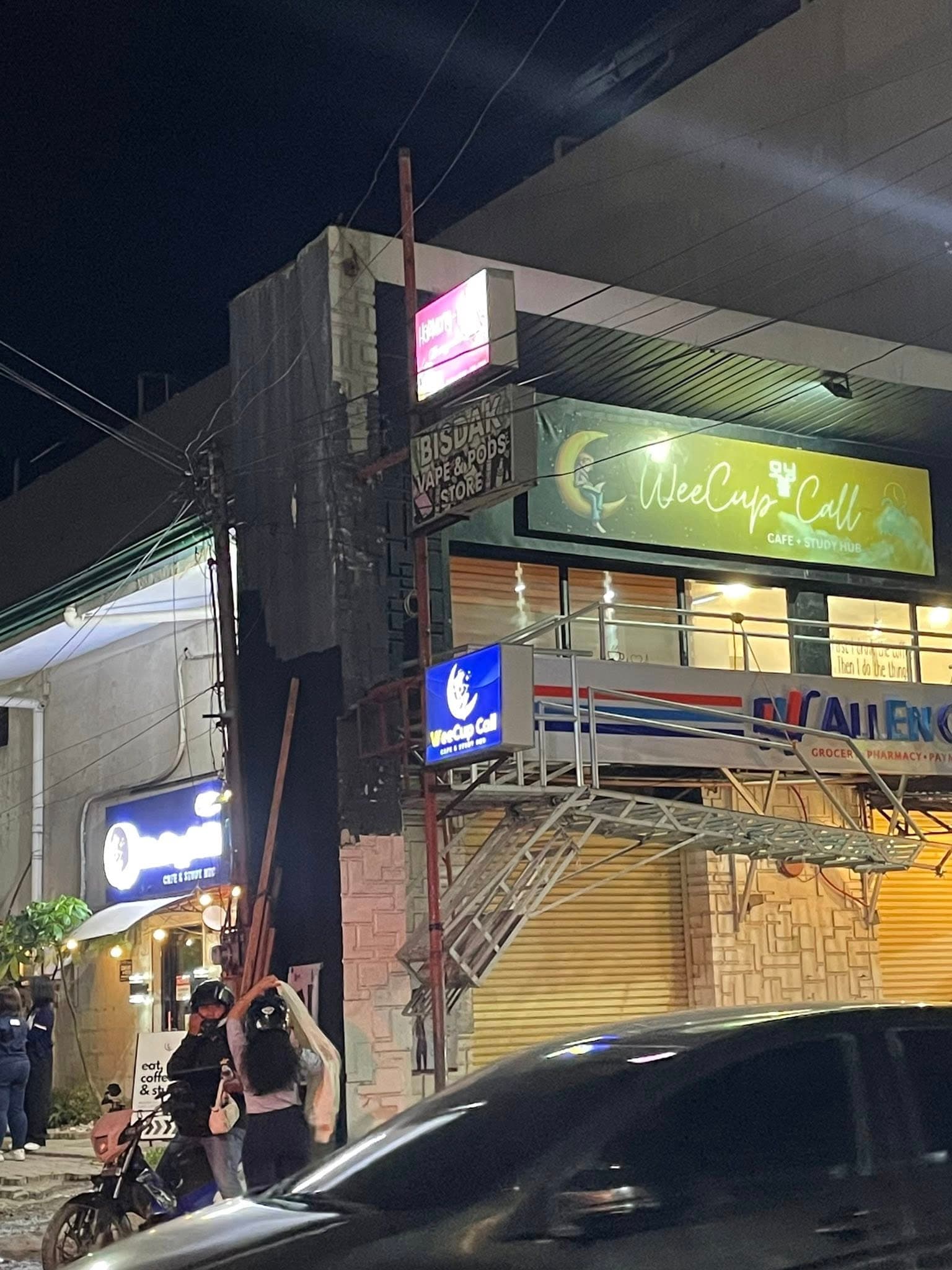 WeeCup Call Cafe exterior signage at night