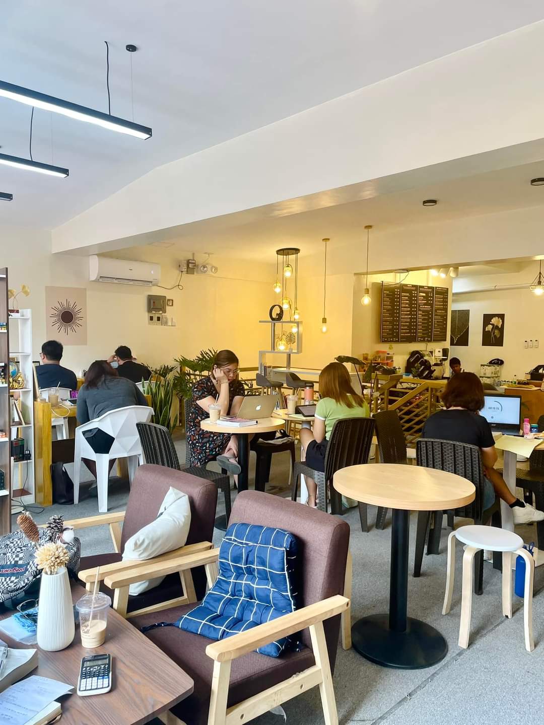 Inside WeeCup Call Cafe with study tables and cafe seating